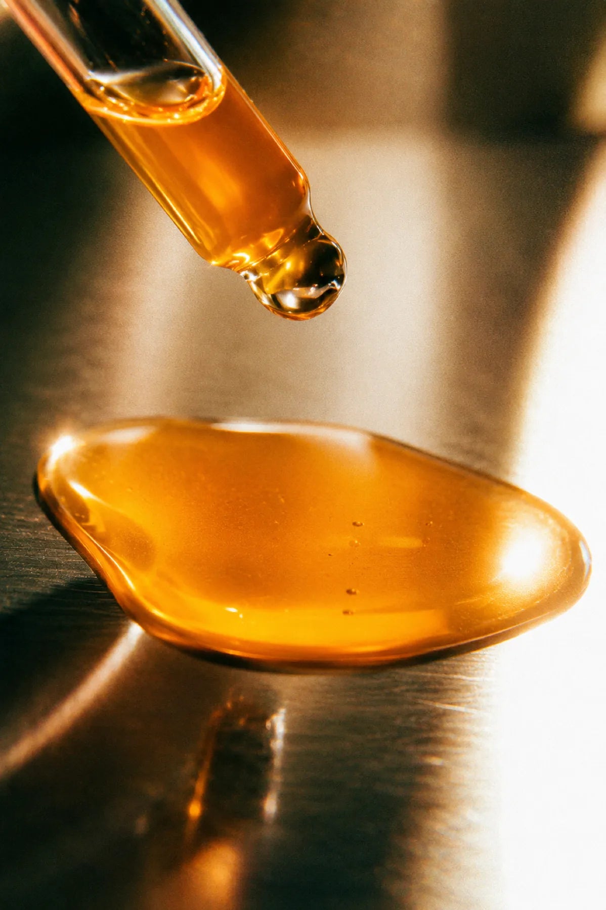Amber sea buckthorn oil in a glass pipette